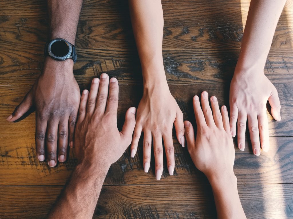 diverse hands together on table