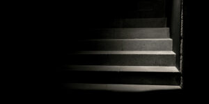 a light cast shadows on step in the darkness